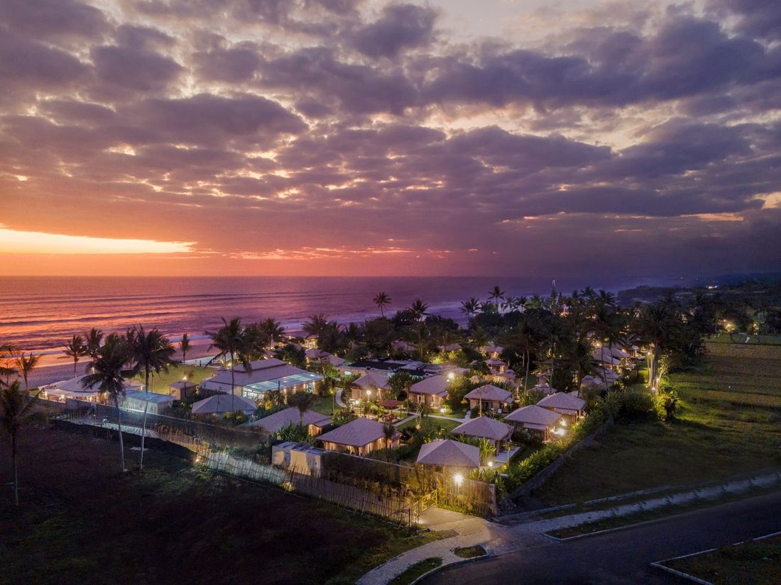 Aerial view of the resort by the ocean at sunset