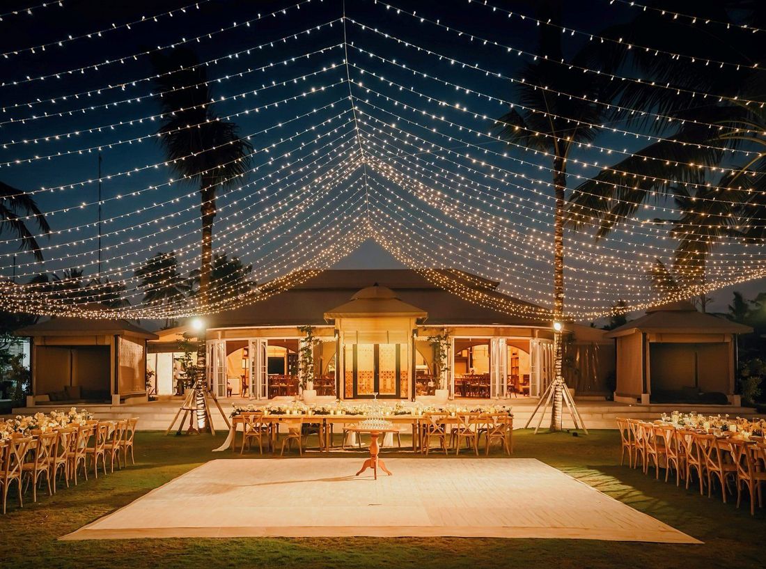 The event lawn under string lights at night